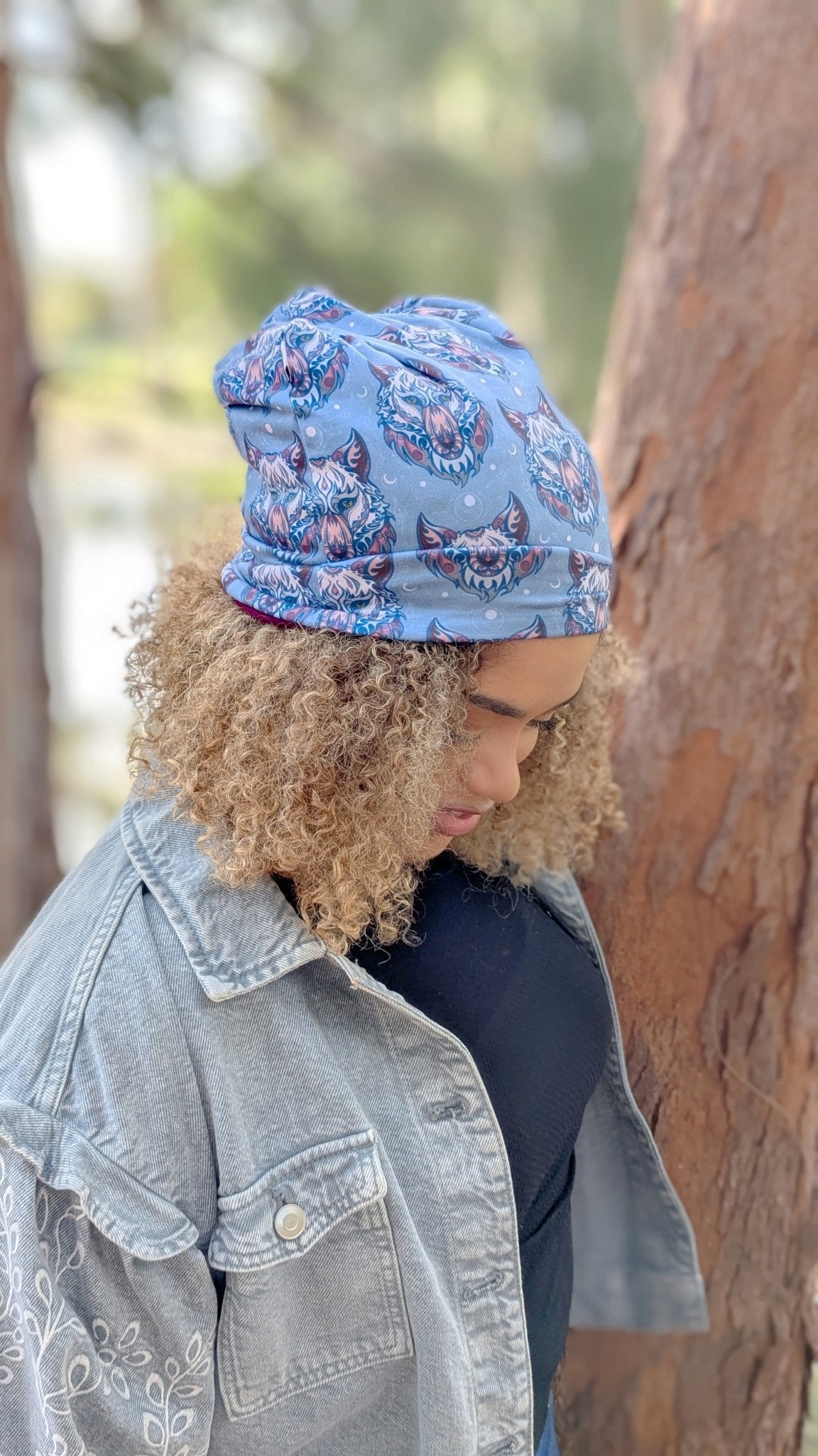 Person wearing a blue beanie with floral patterns outdoors
